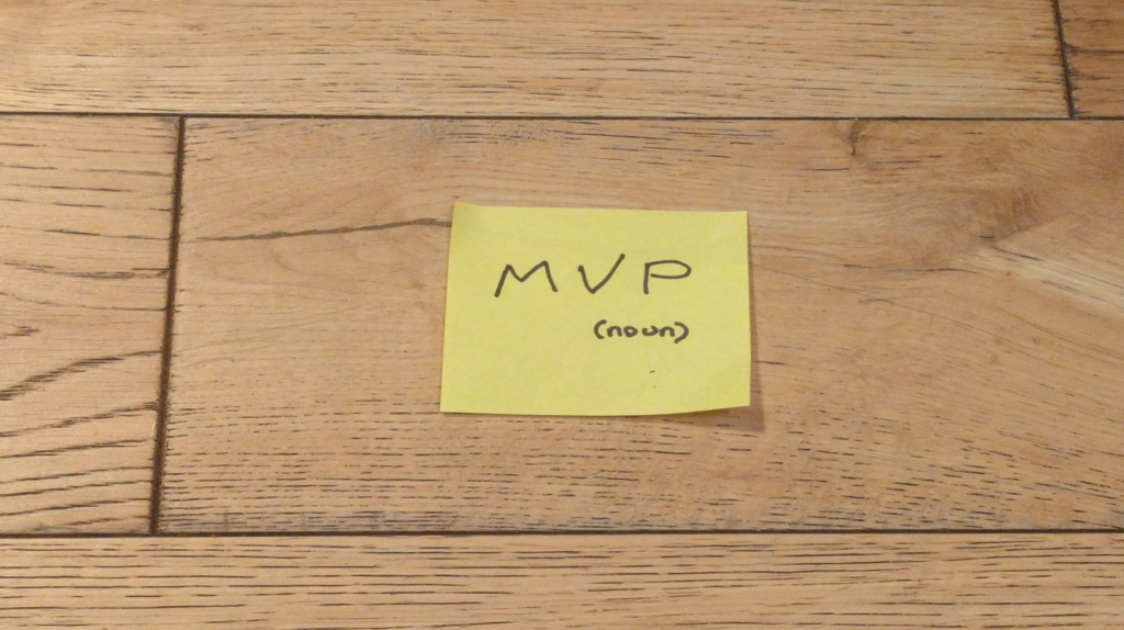 Post-it on a wooden floor: "MVP (noun)"