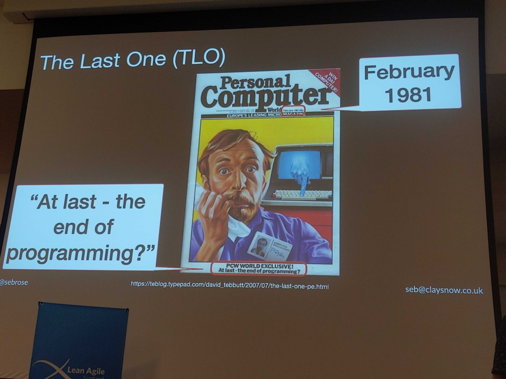 Slide titled "The Last One (TLO)", showing the cover of Personal Computer magazine from February 1981. Title at the bottom is "At last - the end of programming?".

Main image on the magazine over is a glum-looking programmer, in front of a computer that has a hand coming out of the screen to type its own keys.