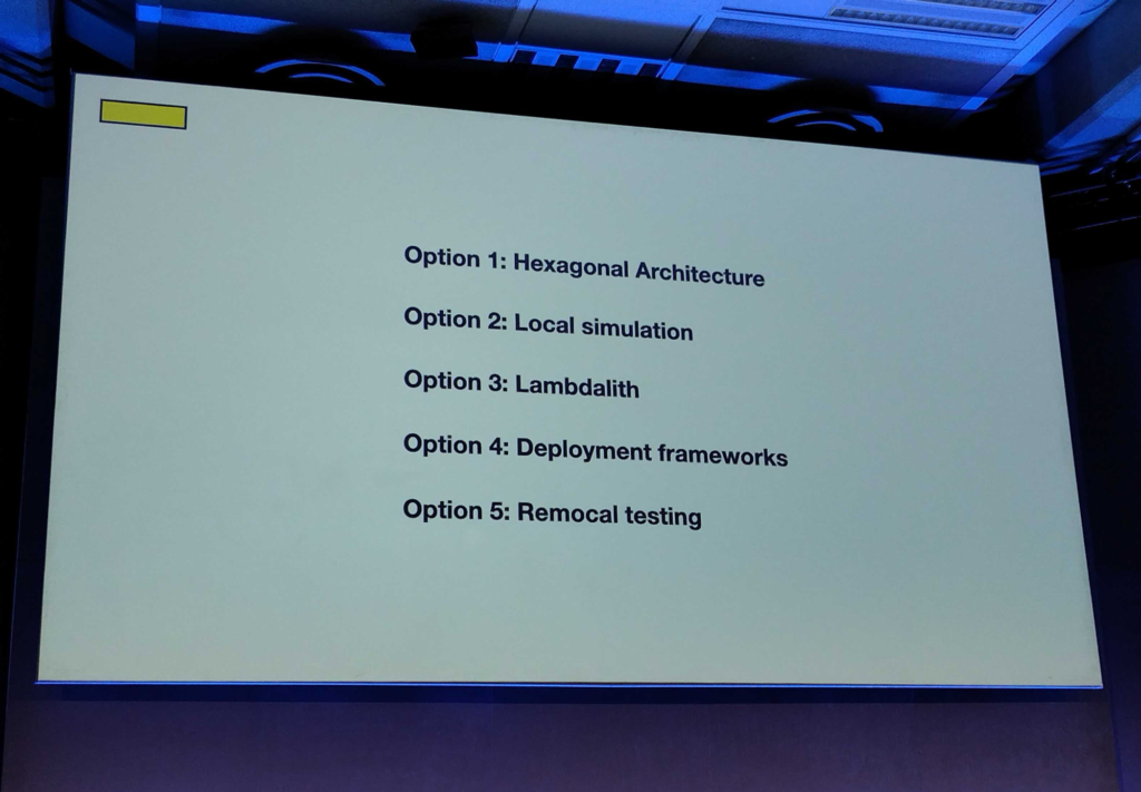 Photo of a slide showing a list:

"Option 1: Hexagonal architecture
Option 2: Local simulation
Option 3: Lambdalith
Option 4: Deployment frameworks
Option 5: Remlocal testing"
