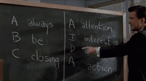 A man in a suit points to a chalkboard and reads out: "A: Always, B: Be, C: Closing".