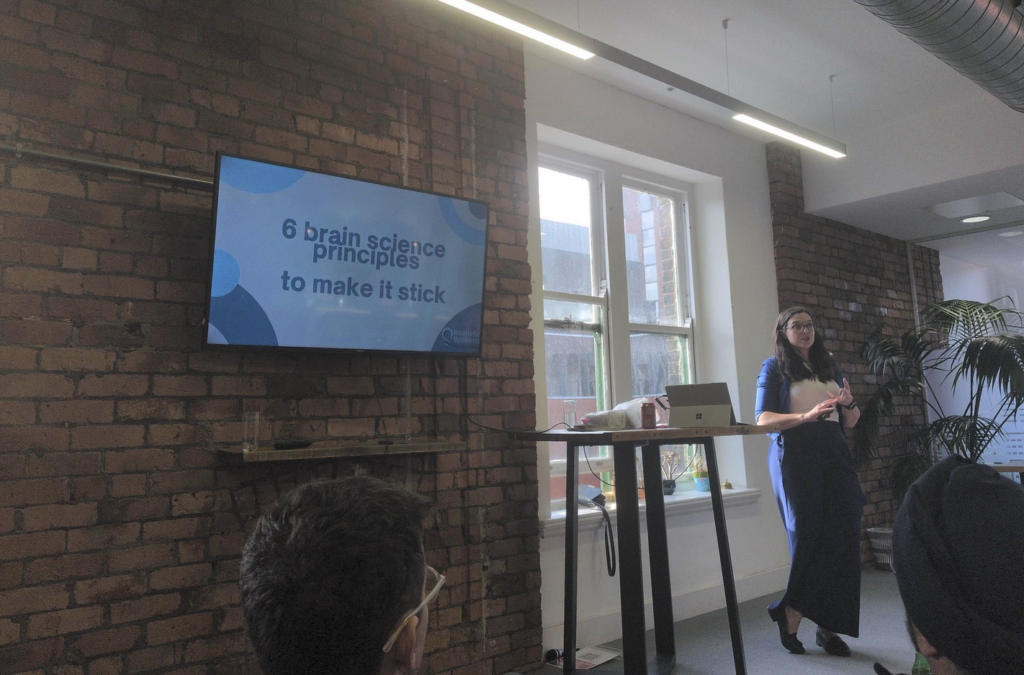 Photo of Rachelle presenting in front of her title slide.